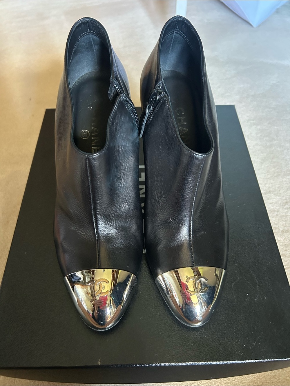 CHANEL Black Leather Ankle Boots with Metallic Cap Toe